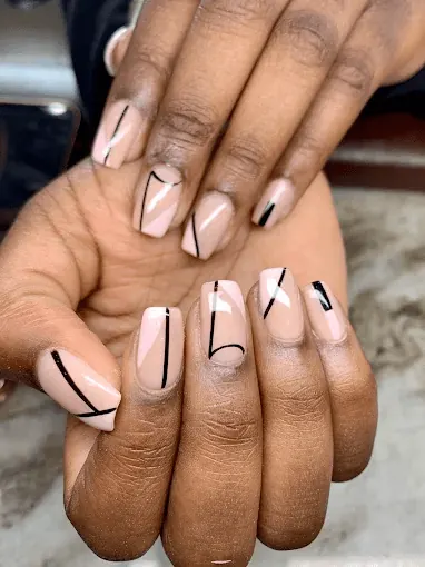 Teal and white stiletto nails with gold line work