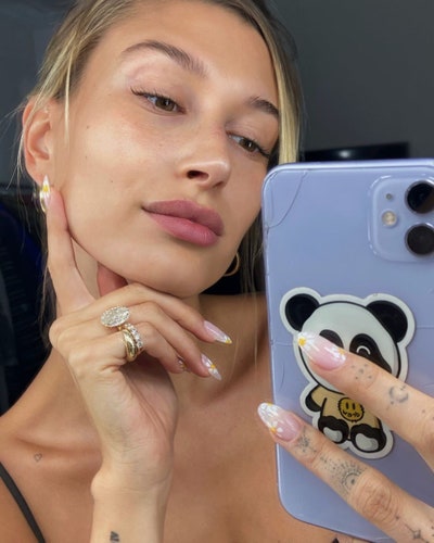 Image may contain Human Person Face Hailey Rhode Baldwin Finger Jewelry Accessories Accessory Ring and Electronics