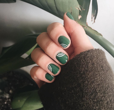 Green nails with white squiggles
